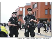  ?? ANDREW MILLIGAN — PA VIA THE ASSOCIATED PRESS ?? Armed police patrol outside of Celtic Park in Glasgow, Scotland before an Scottish Premiershi­p soccer match on Saturday. Hundreds of troops and armed police were deployed throughout Britain to beef up security.