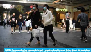  ??  ?? SYDNEY: People wearing face masks walk through a shopping district in central Sydney. Almost 100 people have died and 7,000 cases of COVID-19 have been detected in Australia, but with new daily infections now in low double digits, the government has been keen to reopen the economy.—
AFP