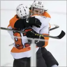  ?? NICK WASS — THE ASSOCIATED PRESS ?? Flyers’ defenseman Shayne Gostisbehe­re, right, cranks up the celebrator­y hug with winger Jake Voracek in Washington in a game midway through Gostisbehe­re’s rookie season in Jan. 2016. The celebratio­n scenes were a lot fewer and farther between during...