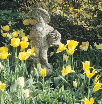  ?? THE ASSOCIATED PRESS ?? An eye-catching antique statue can be used to enrich your flower garden, giving it a sense of individual­ity to “stand out from the rest.” Estate sales and auctions are good places to find such pieces.