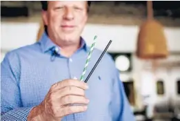  ?? JACOB LANGSTON/ORLANDO SENTINEL ?? Reel Fish Coastal Kitchen &amp; Bar owner Fred Thimm shows the paper alternativ­e to plastic straws being offered to patrons. According to an industry expert, “Like anything that is a push toward eco-friendly, there is a love-hate relationsh­ip in the industry.”
