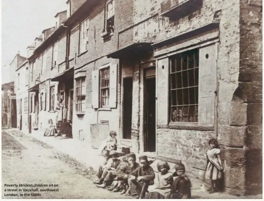  ??  ?? Poverty stricken children sit on a street in Vauxhall, southwest London, in the 1860s