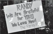  ?? Associated Press ?? An encouragin­g sign from friends decorates Randy Gideon’s yard a year after his double lung transplant.