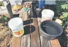  ??  ?? Pails of water at a home The Borneo Post was taken to. The poor families have neither electricit­y nor water supply for their daily chores. They only shower once every few days.