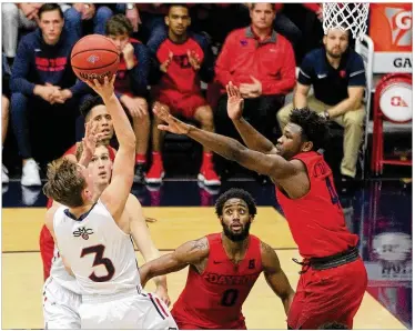  ?? DAVID JABLONSKI / STAFF ?? Saint Mary’s Emmett Naar makes a shot against Dayton in the final seconds of the first half Tuesday in Moraga, Calif. UD led at the half, but the Gaels pulled away in the final seven minutes.