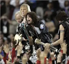  ?? MICHAEL CONROY — THE ASSOCIATED PRESS ?? Aerosmith performs during Super Bowl XXXVIII in 2004, a notable change from when high school and college marching bands took center stage. Over the years, the halftime shows have turned into one of sports’ biggest spectacles.