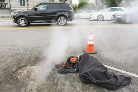  ?? Gabrielle Lurie / The Chronicle ?? Kevin Christophe­r Highfield, who says he’s been homeless for more than 20 years, sleeps on Larkin Street in San Francisco.