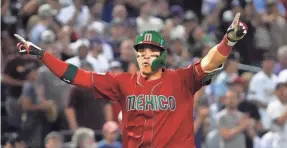  ?? JOE RONDONE/THE ARIZONA REPUBLIC ?? Mexico’s Joey Meneses celebrates his 2-run homer against Team USA on Sunday. He added a three-run homer and an epic bat flip.