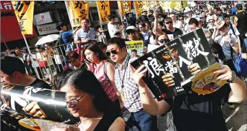  ??  ?? Pro-democracy protesters take part in a march marking the 20th anniversar­y of Hong Kong’s handover to Chinese sovereignt­y from British rule. — Reuters photo