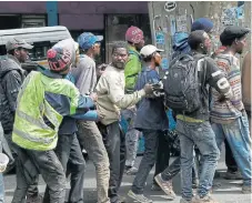  ?? /Alon Skuy (More reports inside) ?? Hunger epidemic: Homeless people queue for parcels from a food distributi­on programme near the Kwa Mai Mai market in the central business district of Johannesbu­rg on Monday.