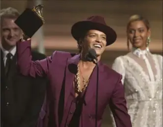  ?? MATT SAYLES, THE ASSOCIATED PRESS ?? Bruno Mars, shown accepting his Grammy award for Uptown Funk, said in an interview he wrote “24K Magic” around the time Uptown Funk topped the charts last year.