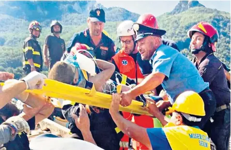  ??  ?? Mattias Marmolo, seven, is carried on a stretcher by rescuers after spending several hours buried in a house destroyed by the earthquake in Ischia. Top left; residents survey the damage