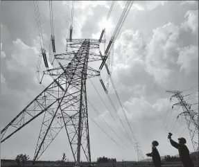  ?? PROVIDED TO CHINA DAILY ?? State Grid engineers inspect a power distributi­on tower in Zaozhuang, Shandong province.