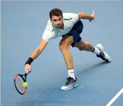  ?? Reuters ?? Bulgaria’s Grigor Dimitrov plays a shot against Belgium’s David Goffin during his group stage match of ATP World Tour Finals. —