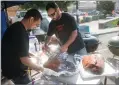  ??  ?? The Lupio brothers Richard, left, and Vincent get ready for rib cookoff competitio­n Saturday at Pioneer Days..