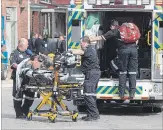  ?? BOB TYMCZYSZYN THE ST. CATHARINES STANDARD ?? A second person is taken away by Niagara EMS as Niagara Regional Police were searching for suspects after a shooting Thursday in the downtownSt. Catharines.