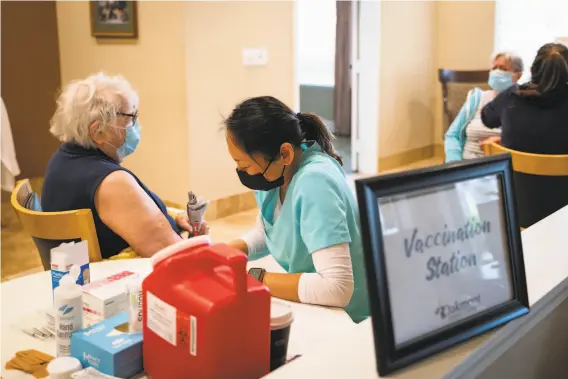  ?? Photos by Sarahbeth Maney / Special to The Chronicle ?? Mary Ann Remele (left) talks with registered nurse Xenly Ancheta. Most Bay Area counties report more women than men are getting vaccinated.