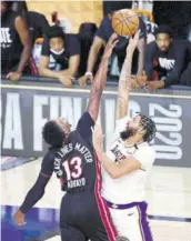  ?? (Photo: AFP) ?? Bam Adebayo (#13) of the Miami Heat and Anthony Davis of the Los Angeles Lakers fight for possession during the fourth quarter in Game Six of the 2020 NBA Finals at Adventheal­th arena at ESPN Wide World Of Sports Complex on Sunday in Lake Buena Vista, Florida.