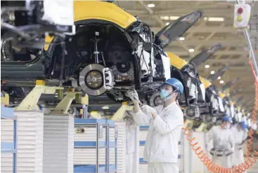  ?? — AFP ?? An employee working on an assembly line at an auto plant of Dongfeng Honda in Wuhan in China’s central Hubei province, as data shows the country’s economy expanded at its fastest pace on record during the first quarter.