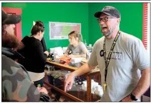  ?? AP ?? Loren Kruesi (right), owner of CBD Express, talks with a customer last month during the store’s grand opening in Salem, Ore. The business sells cannabidio­l oils and other products containing the hemp extract.