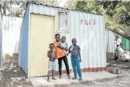  ??  ?? Left, Emihle Nkomana outside his family’s3m x 3m home with infant brother Uminathi in his arms and neighbours Ziyanda and Simphiwe Mcaphukisi. Below, citizen journalist Owen Xubuzane interviews tattoo artist Phelo Mantangana.