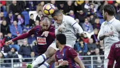  ??  ?? EIBAR: Real Madrid’s Mariano Diez Mejia, center, heads the ball during the Spanish La Liga soccer match between Real Madrid and Eibar, at Ipurua stadium, in Eibar, northern Spain, yesterday. Real Madrid won the match 4-1. — AP