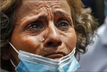  ?? Hussein Malla/Associated Press ?? A Lebanese woman, whose son is missing after the explosion Tuesday that hit the seaport of Beirut, cries as she waits outside the port to receive informatio­n from the rescue teams Thursday.