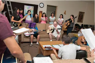  ?? Staff photo by Jerry Habraken ?? ■ Pete Hamer, center, plays with St. Edward Catholic Church’s Hispanic choir during a practice session Aug. 31 at the church’s Bishop Graves Education Building.