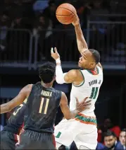  ?? WILFREDO LEE / AP ?? Miami’s Bruce Brown Jr., passing during a January game, said he used his personalit­y in interviews “to bring everybody up and make everybody smile.”