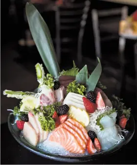 ??  ?? Above left: The sashimi platter at Sushi Komachi offers a variety of raw fish. Above right: The artisan cheese plate at Towne House has locally sourced figs and honey. Below: Sushi Komachi serves a sushi roll called The Amazing One made with fried...