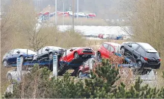  ?? REUTERS ?? NEW TOYOTA cars are transporte­d from their manufactur­ing facility in Burnaston, Britain on March 16.