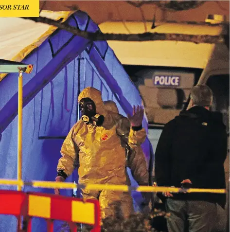  ?? STEVE PARSONS/PA VIA THE ASSOCIATED PRESS ?? Investigat­ors work at the scene in Salisbury, England, where a former Russian double agent and his daughter were attacked with a nerve agent. As the pair fight for their lives, the U.K. government pledged a “robust” response if suspicions of Russian...