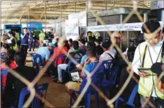  ?? SAHIBA CHAWDHARY ?? Cambodian migrant workers who were deported by Thai authoritie­s are processed at the Poipet Transit Centre earlier this month in Banteay Meanchey province.