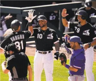  ?? Ross D. Franklin / Associated Press ?? Chicago’s Andrew Vaughn, the former Cal first baseman, celebrates his threerun homer against the Rangers with teammates Yoan Moncada (10) and Jose Abreu (79).