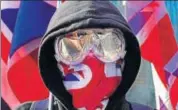  ??  ?? A protester wears a British flag mask at a rally in Hong Kong.
AP FILE