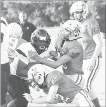  ?? Fred Conley • Times-Herald ?? At left, a Palestine-Wheatley player moves into position to make a tackle on a Cross County running back during Monday's preseason jamboree played at Patriot Field. Above, a trio of PW defenders converge to make a stop on a Marianna Lee running back during one of the preseason jamboree games played Monday.