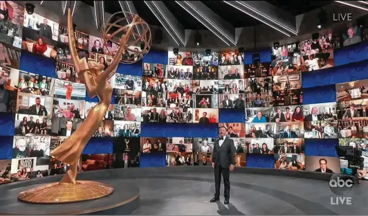  ?? Associated Press ?? Host Jimmy Kimmel finds himself alone — well, almost — in the theater at the 72nd Emmy Awards.