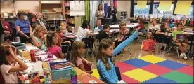  ?? JEREMY P. KELLEY / STAFF ?? Beavercree­k students work on a lesson during a visit from state superinten­dent Paolo DeMaria in 2017. The district will begin planning budget cuts.