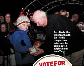  ??  ?? Rory Doyle, the winner of South East Radio competitio­n to turn on the lights, gets a helping hand from Tony