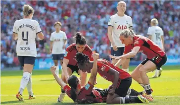  ?? TOM JENKINS/ THE GUARDIAN ?? Rachel Williams receives congratula­tions from her teammates after scoring Manchester United’s second goal