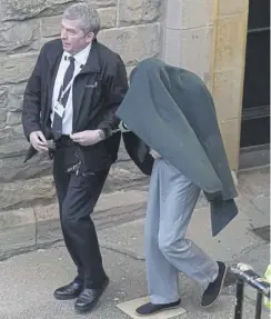  ?? PICTURE: PA ?? Andrew Miller, right, who is also known as Amy George, being led from Selkirk Sheriff Court following an earlier hearing