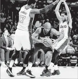  ?? Chris Carlson
Associated Press ?? I T’S A LEANING TOWER of Lakers, as Phoenix forward P. J. Tucker tries to split the defense of Roy Hibbert, left, and Jordan Clarkson.