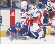  ?? Claus Andersen / Getty Images ?? Ryan Strome (16) of the New York Rangers tries to break past Morgan Rielly (44) of the Toronto Maple Leafs at Scotiabank Arena on Thursday in Toronto. The Maple Leafs won 2-1.