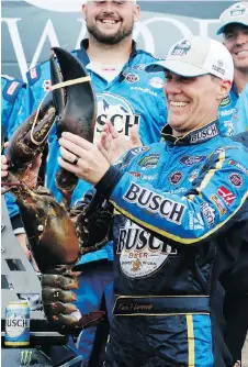  ?? MARY SCHWALM/THE ASSOCIATED PRESS ?? Kevin Harvick smiles as he holds up a large lobster in Victory Lane after winning the NASCAR Cup Series auto race on Sunday at New Hampshire Motor Speedway in Loudon.