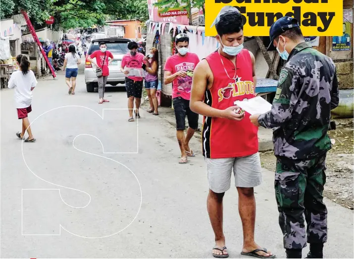  ?? / ALEX BADAYOS ?? CONTAINMEN­T MEASURE. A policeman deployed in Barangay Guadalupe, Cebu City checks the quarantine pass of a resident. The recent rise in the number of active coronaviru­s cases in the barangay has prompted local officials to strictly enforce quarantine protocol like the curfew and the stay-at-home order. They will also implement a “Sunday lockdown” starting on Jan. 24, 2021. Only authorized persons outside of residence and those with essential errands will be allowed outdoors. The lockdown will only be lifted when the number of cases goes down, according to Barangay Captain Michael Gacasan.