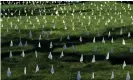  ?? Photograph: Timothy A Clary/AFP via Getty Images ?? White markers on the lawn at the First Congregati­onal church of Greenwich to honor the many lives lost as result of the pandemic, in Old Greenwich, Connecticu­t.