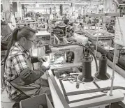  ?? Ted S. Warren / Associated Press file ?? A worker at the C.C. Filson Co. manufactur­ing plant stitches a belt at a sewing machine in Seattle. U.S. factory production fell 0.1 percent last month.