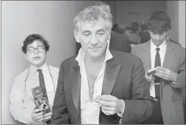  ?? John Duricka Associated Press ?? BERNSTEIN heads to his dressing room in May 1969 after his last performanc­e as music director of the New York Philharmon­ic, which he had led since 1958.