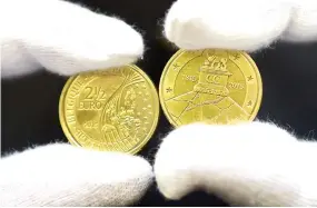  ??  ?? COMMEMORAT­IVE coins to mark the 200th anniversar­y of The Battle of Waterloo are displayed during a ceremony held to unveil the €2.5 coin at the Royal Belgium Mint in Brussels on June 8. The coin bears the Lion’s Mound and a diagram of the troops...