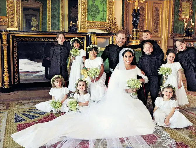  ??  ?? ALL SMILES The new Duke and Duchess of Sussex surrounded by their young bridesmaid­s and page boys in the Green Drawing Room at Windsor Castle. Far right, the newly-weds on the castle’s East Terrace